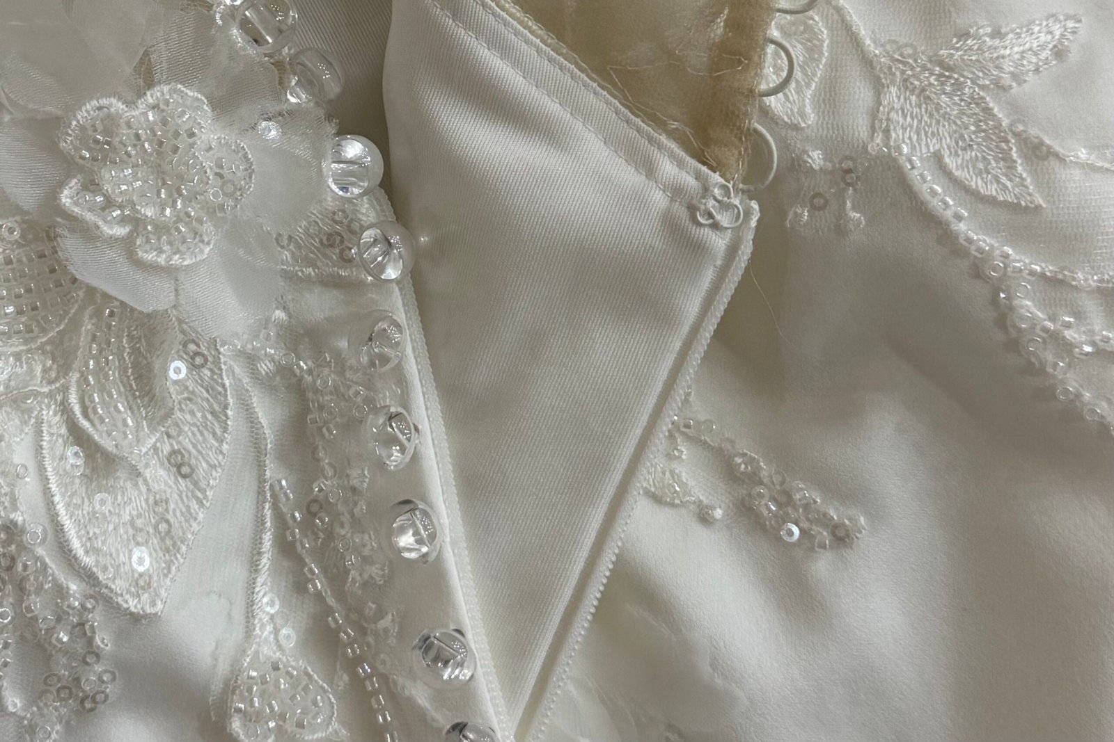steam pressing equipment used on satin wedding dress bodice showing moisture control